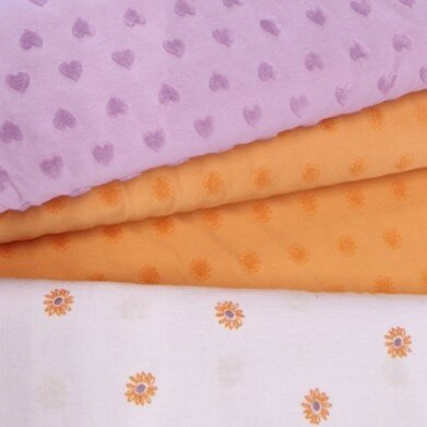 badstof tricot zonnetjes oranje met hartjes lila en lila oranje zonnebloem hydrofiel KicKenStoffen